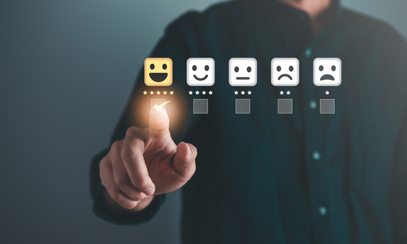 Happy to sad faces with stars correlating to how happy the face is with someone selecting an option in mid-air